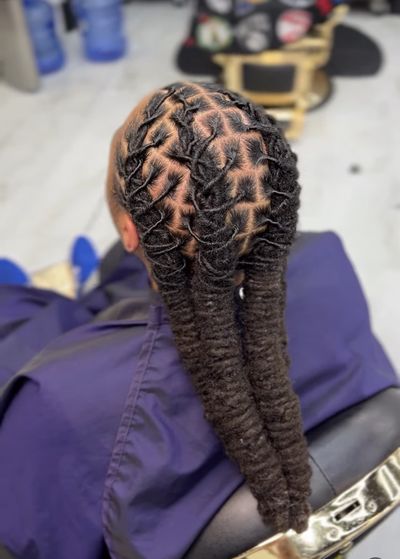 Intricate loc styling from behind in the Inspirada barber chair